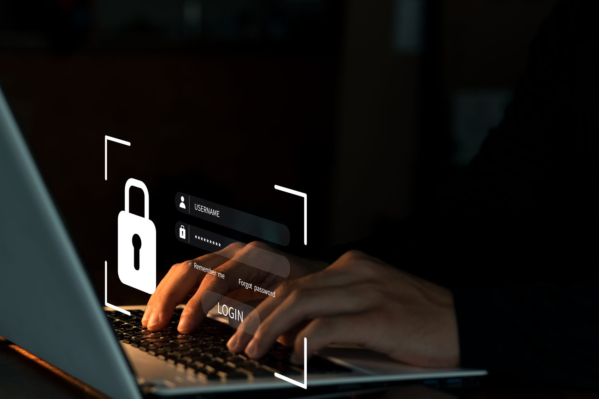 Hands typing on a laptop keyboard in a dark setting, with a virtual login screen overlay showing a padlock icon, username, password fields, and a login button, symbolizing cybersecurity or online authentication.